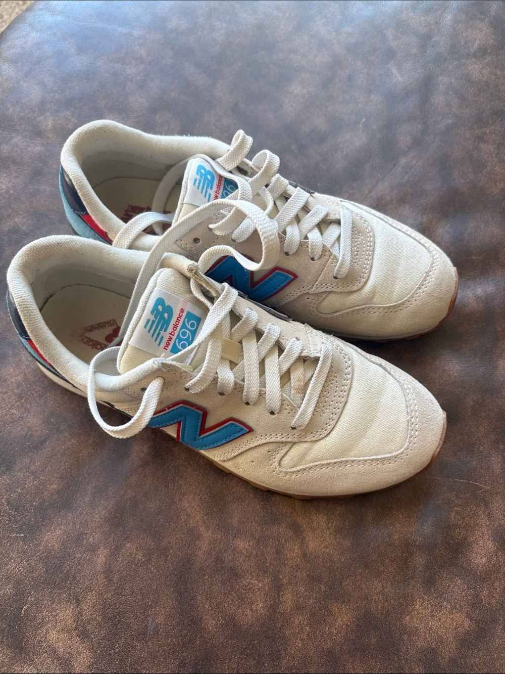 New Balance women’s 696 Sneakers — Off-White with Blue & Red Details